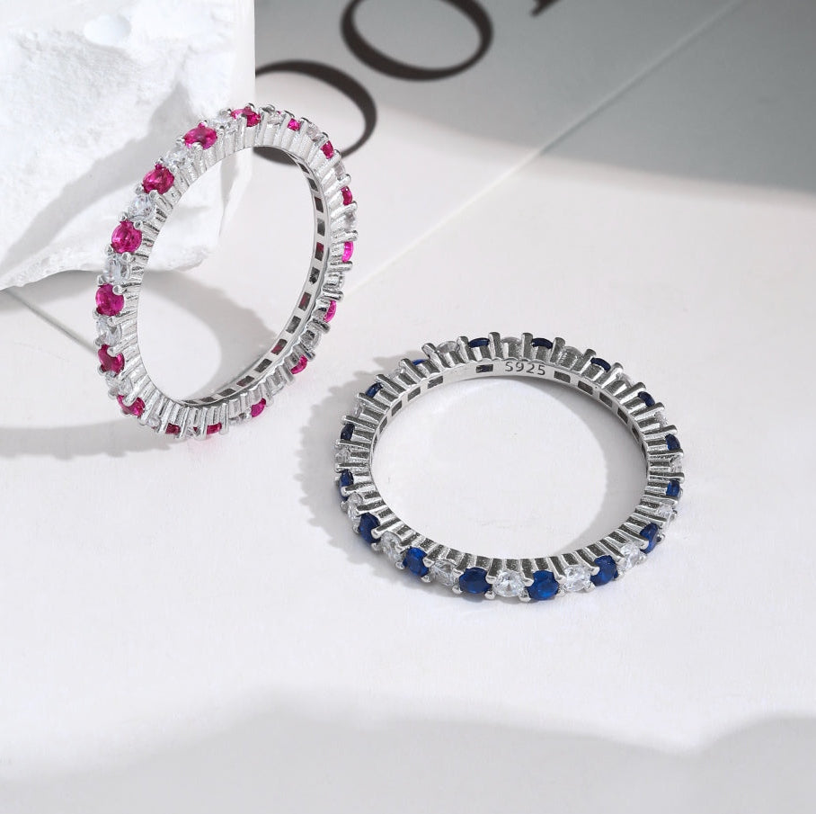 Pair of hoop earrings with gemstones on a light background