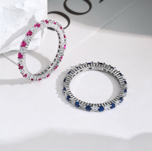 Pair of hoop earrings with gemstones on a light background