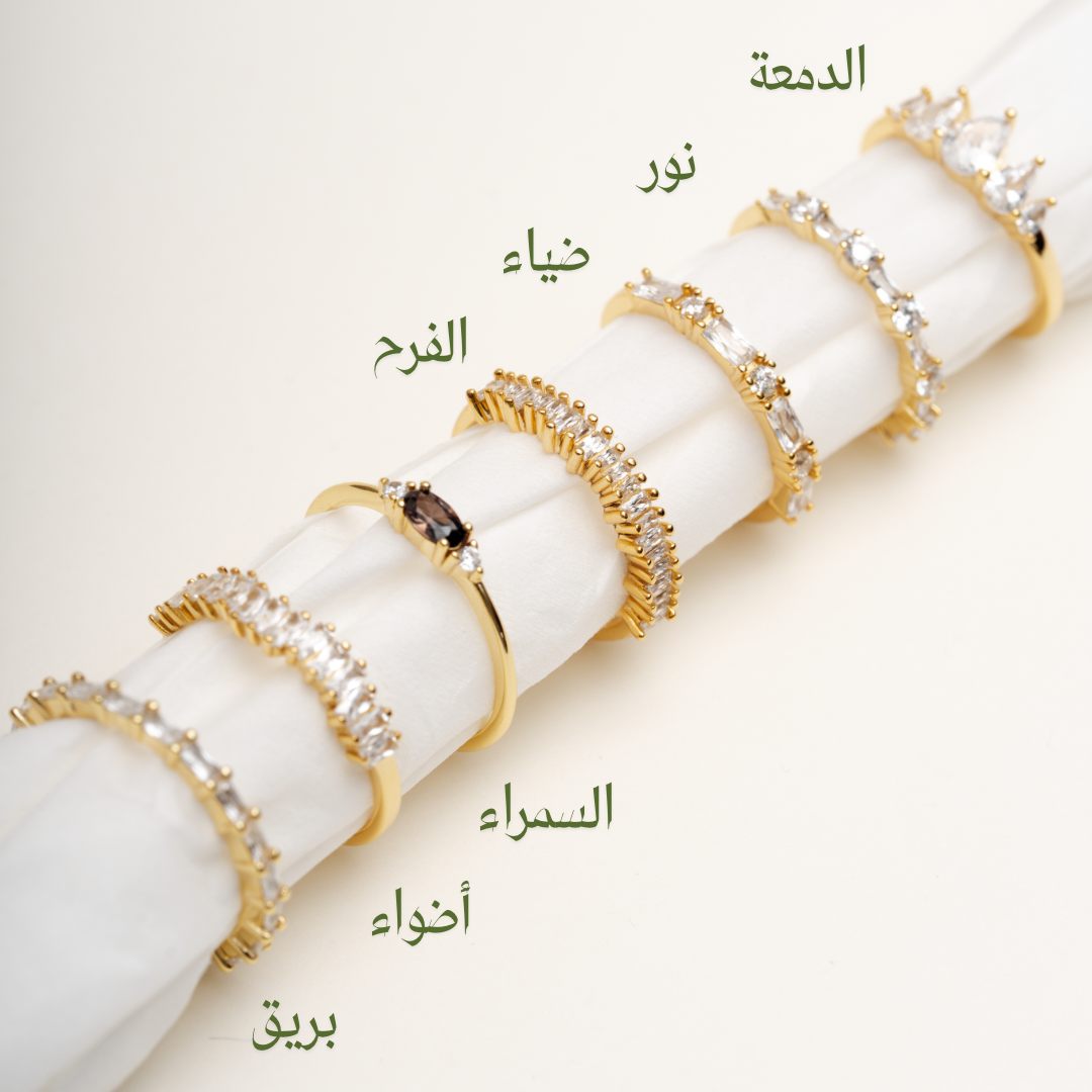 Stackable gold plated CZ rings collection featuring Bareeq, Nour, Damaa, Alfarah designs on white background - Luméra Designs Kuwait luxury jewelry